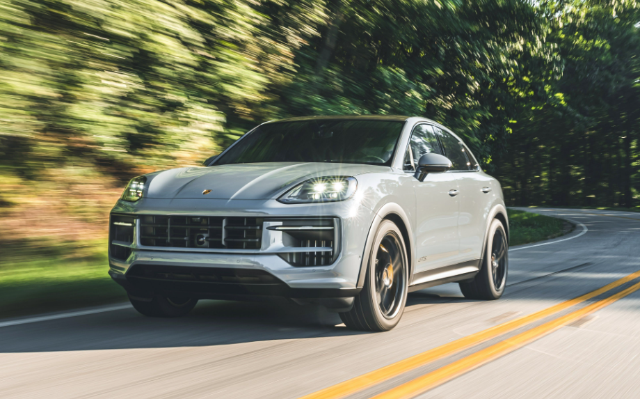 Premium white Porsche luxury SUV on a scenic road
